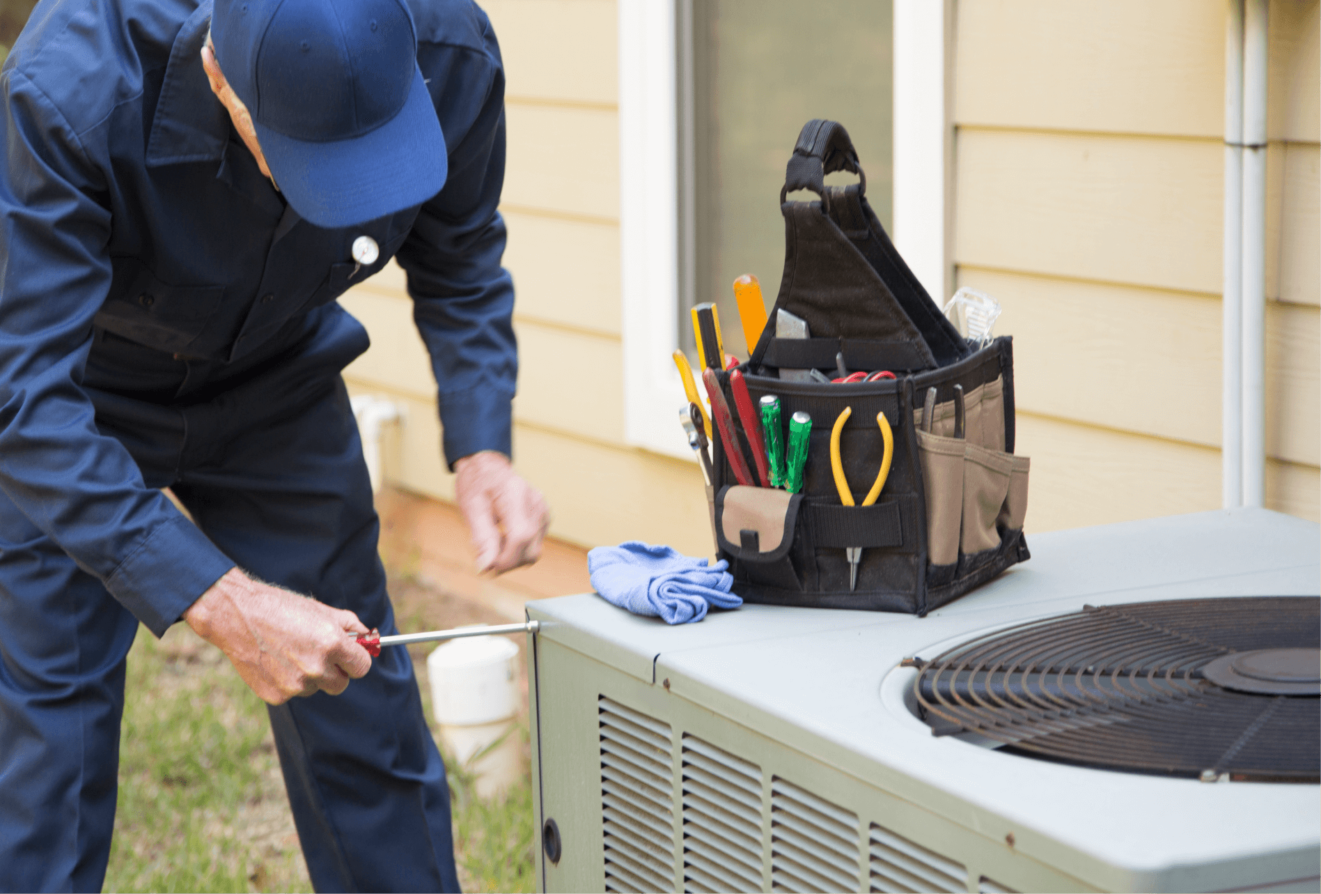 Here's an alt tag for the image: Technician repairing air conditioning unit.